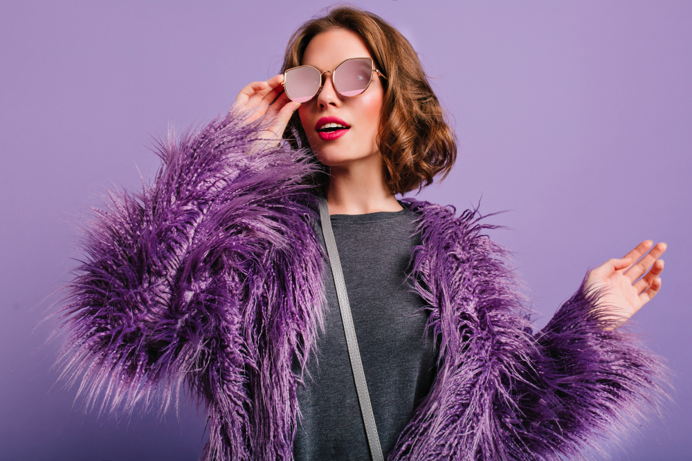 indoor-portrait-stylish-european-female-model-glasses-posing-purple-background