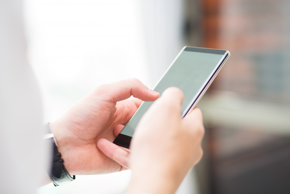 close-up-unrecognizable-man-touching-smartphone-screen